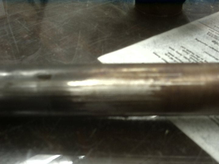 Shaft wear, shot against the paperwork so the photo can never be separated from what it documents.