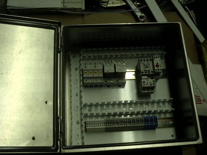 That panel's interior, wired out before the frame ever moves.