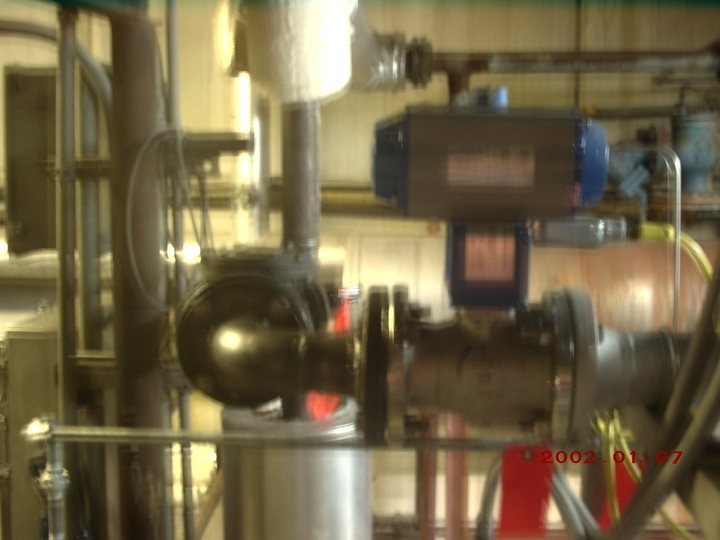 Plant interior. Pumps, headers, insulated lines and a control panel bolted to the middle of it.
