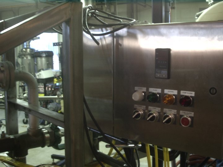The skid's own control station mounted to the frame — it arrives on site as one thing that already knows how to run itself.