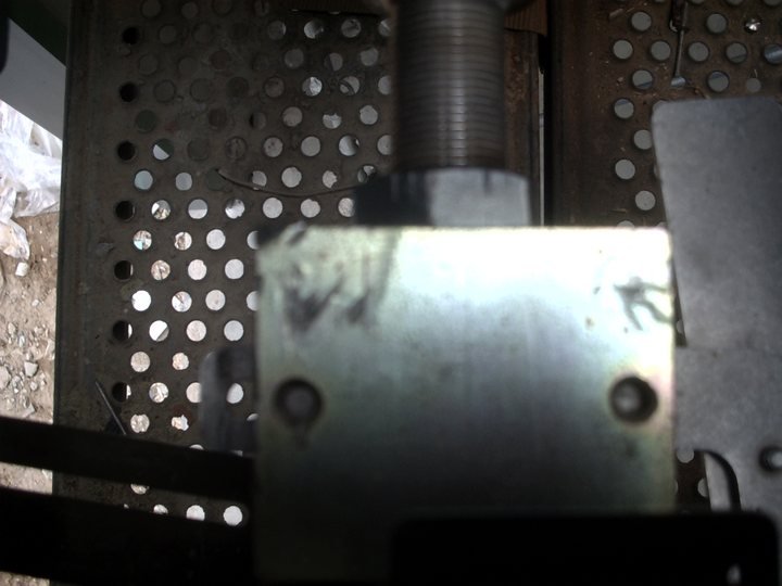 Actuator and linkage. Getting a camera in here is half the diagnosis, and it's the half you can take back to the hotel.