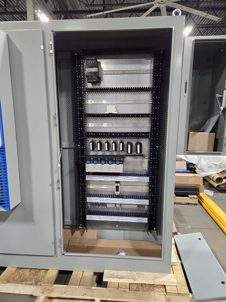 Finished cabinet on the pallet. Blue duct, breakers set, everything labeled and closed.